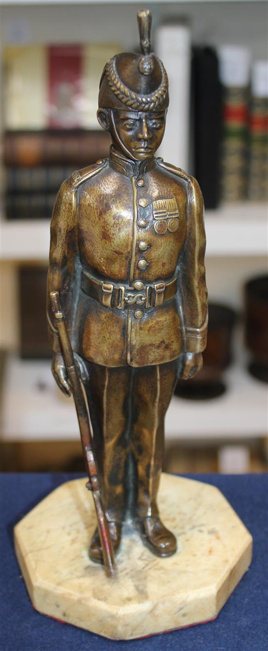 An early 20th century patinated military bronze model of a Kings Royal Rifle Corps soldier, 10.5in.